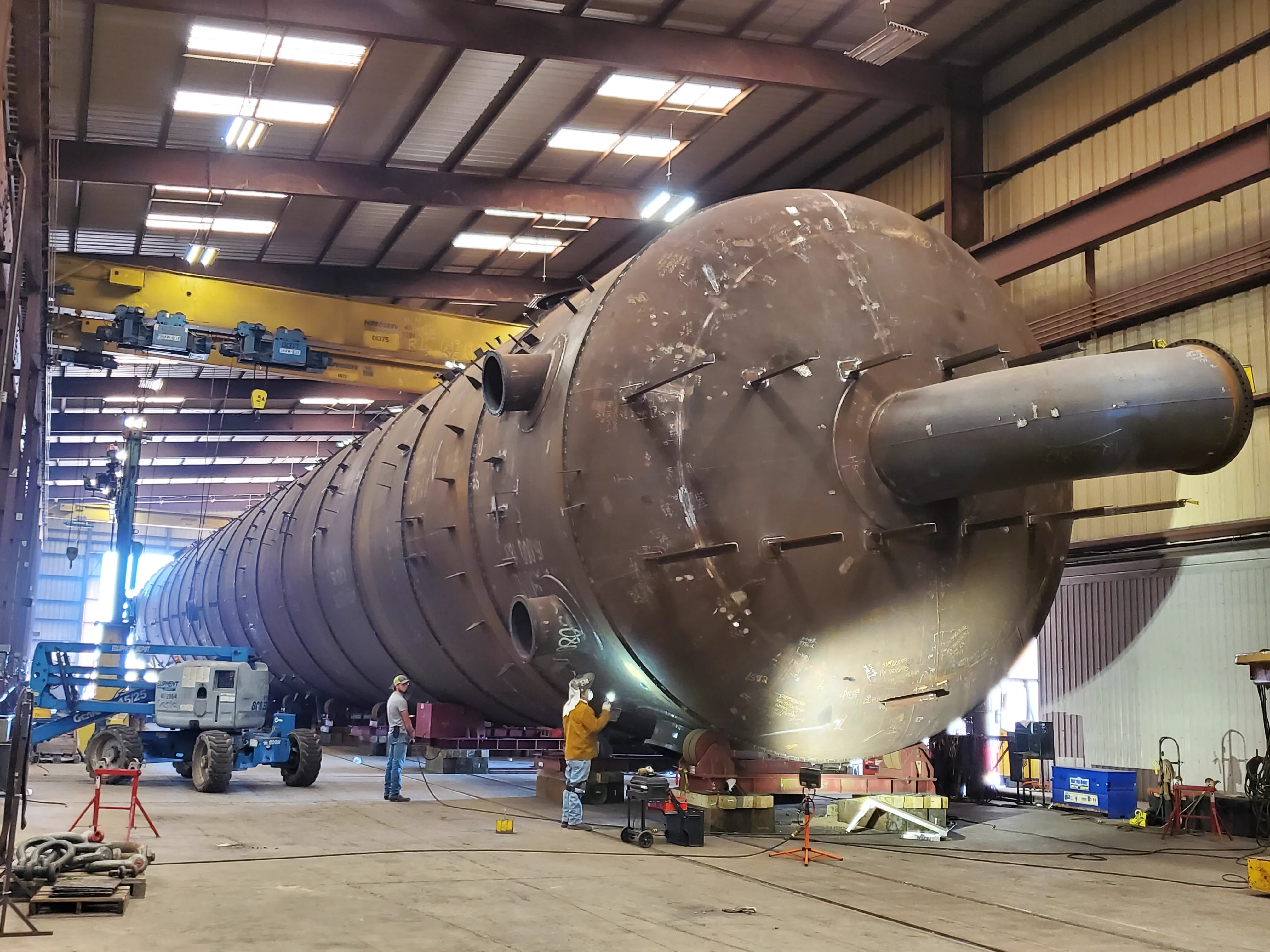 Interior fabrication bay showing heavy steel fabrication capability.